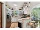 Well-appointed kitchen with stainless steel appliances and seamless connection to sunroom at 12472 Country White Cir, Tampa, FL 33635