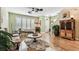 Comfortable living room with hardwood floors, ceiling fan and plenty of natural light at 12472 Country White Cir, Tampa, FL 33635