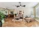 Bright and open living room with hardwood floors, ceiling fans, and comfortable seating at 12472 Country White Cir, Tampa, FL 33635