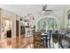 Open living and dining area with hardwood floors and connection to kitchen and bathroom at 12472 Country White Cir, Tampa, FL 33635