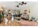 Spacious living area with hardwood floors seamlessly connecting to dining and kitchen at 12472 Country White Cir, Tampa, FL 33635