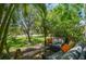 Relaxing patio with comfortable seating surrounded by lush tropical landscaping at 12472 Country White Cir, Tampa, FL 33635