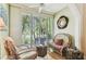 Bright sitting area featuring large windows with plantation shutters and comfortable, stylish decor at 12472 Country White Cir, Tampa, FL 33635