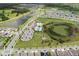 Stunning aerial view of a Primary-planned community with pool, playground, and scenic ponds at 12643 Shetland Walk Dr, Lithia, FL 33547