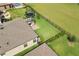 Aerial view of a property with a fenced backyard, patio with pergola, and well-maintained landscaping at 12643 Shetland Walk Dr, Lithia, FL 33547