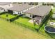 Aerial view of a home with a fenced backyard, pergola-covered patio, and well-manicured lawn at 12643 Shetland Walk Dr, Lithia, FL 33547