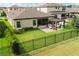 A backyard showcasing a patio with a pergola, outdoor seating, a fenced yard, and lush landscaping at 12643 Shetland Walk Dr, Lithia, FL 33547