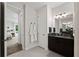Well-lit bathroom with granite countertop, dark cabinets, and tile flooring, offering style and functionality at 12643 Shetland Walk Dr, Lithia, FL 33547