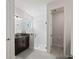 Modern bathroom with a glass-enclosed shower, granite countertop, and a neutral color scheme at 12643 Shetland Walk Dr, Lithia, FL 33547