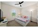 Inviting bedroom with storage bed, natural light, and ceiling fan, ideal for relaxation at 12643 Shetland Walk Dr, Lithia, FL 33547