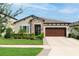 Charming single-story home featuring stone accents, manicured landscaping, and a two-car garage at 12643 Shetland Walk Dr, Lithia, FL 33547