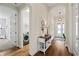 Inviting entryway featuring hardwood floors and leading to the laundry room and the rest of the house at 12643 Shetland Walk Dr, Lithia, FL 33547