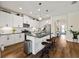 Modern kitchen featuring white cabinets, granite countertops, a large island, and stainless steel appliances at 12643 Shetland Walk Dr, Lithia, FL 33547