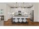 Bright kitchen boasts white cabinets, granite counters, modern appliances, and a central island with seating at 12643 Shetland Walk Dr, Lithia, FL 33547