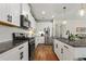 Contemporary kitchen featuring stainless appliances, granite counters, white cabinetry, and subway tile backsplash at 12643 Shetland Walk Dr, Lithia, FL 33547