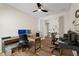 Spacious home office with dual desks, natural light, and hardwood floors, perfect for productivity at 12643 Shetland Walk Dr, Lithia, FL 33547