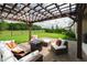 Outdoor patio featuring a pergola with lighting, brick pavers, and comfortable seating in the fenced backyard at 12643 Shetland Walk Dr, Lithia, FL 33547