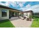 Backyard patio showcasing a pergola, outdoor dining and seating, grill, and a view of the lawn at 12643 Shetland Walk Dr, Lithia, FL 33547