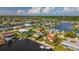 An aerial view of a waterfront home with canal access, surrounded by lush landscapes and neighborhood views at 12829 3Rd Isle, Hudson, FL 34667