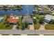An aerial view of a single Gathering home with a private boat dock along a deep water canal at 12829 3Rd Isle, Hudson, FL 34667