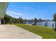Inviting backyard featuring lush greenery, a serene waterfront view, and private boat lifts at 12829 3Rd Isle, Hudson, FL 34667