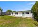 A spacious grassy backyard is the perfect place to gather with Gathering and friends at 12829 3Rd Isle, Hudson, FL 34667