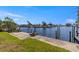 A concrete dock and boat lift offer direct access to the canal and waterfront living at 12829 3Rd Isle, Hudson, FL 34667