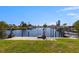 A waterfront property with a dock and boat lift provides access to the canal and open water at 12829 3Rd Isle, Hudson, FL 34667