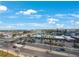 Scenic aerial view of the building, showing the surrounding city and beautiful blue sky with puffy white clouds at 14950 Gulf Blvd # 902, Madeira Beach, FL 33708