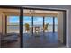 Enclosed balcony with chairs and a table showcases panoramic ocean views at 14950 Gulf Blvd # 902, Madeira Beach, FL 33708