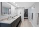 A renovated bathroom with double sinks, modern fixtures, and a glass-enclosed shower at 14950 Gulf Blvd # 902, Madeira Beach, FL 33708