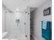 Bright bathroom featuring a large glass shower and a separate towel storage area at 14950 Gulf Blvd # 902, Madeira Beach, FL 33708