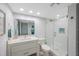 Modern bathroom with sleek vanity, toilet, and walk-in shower with glass door at 14950 Gulf Blvd # 902, Madeira Beach, FL 33708