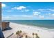 Breathtaking beach view from a high-rise featuring white sand, turquoise water, and palm trees at 14950 Gulf Blvd # 902, Madeira Beach, FL 33708