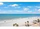 Stunning beach view with turquoise water, white sand and blue skies with fluffy clouds at 14950 Gulf Blvd # 902, Madeira Beach, FL 33708