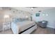 Bedroom with light-colored walls, beach-themed decor, a ceiling fan, and an accent chair at 14950 Gulf Blvd # 902, Madeira Beach, FL 33708