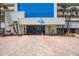 Inviting building entrance with 'Ocean Sands' sign, accessible parking, and well-maintained landscaping at 14950 Gulf Blvd # 902, Madeira Beach, FL 33708