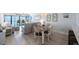 Cozy dining area with ocean views, light colored floors and table for four at 14950 Gulf Blvd # 902, Madeira Beach, FL 33708