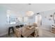 Open-concept dining room with views of the kitchen and beach themed decor at 14950 Gulf Blvd # 902, Madeira Beach, FL 33708