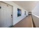Exterior hallway with views of the ocean from multiple windows at 14950 Gulf Blvd # 902, Madeira Beach, FL 33708
