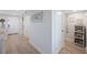 Hallway with a beach theme, featuring light colored floors, doors, and beach themed decorations at 14950 Gulf Blvd # 902, Madeira Beach, FL 33708