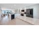 Modern, bright kitchen with stainless steel appliances, granite counters, and an island, open to the living area at 14950 Gulf Blvd # 902, Madeira Beach, FL 33708