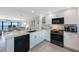 Bright kitchen with stainless steel appliances and granite counters, open to the living area at 14950 Gulf Blvd # 902, Madeira Beach, FL 33708