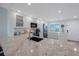 Bright kitchen features granite countertops, stainless steel appliances, and a view from the window at 14950 Gulf Blvd # 902, Madeira Beach, FL 33708