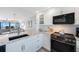 Bright kitchen featuring stainless steel appliances, granite countertops, and open living space at 14950 Gulf Blvd # 902, Madeira Beach, FL 33708