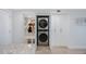 Convenient laundry area with modern stacked washer and dryer next to a mud room at 14950 Gulf Blvd # 902, Madeira Beach, FL 33708