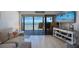 Comfortable living room boasts breathtaking ocean views and a stylish entertainment center at 14950 Gulf Blvd # 902, Madeira Beach, FL 33708