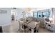 Inviting living space with an open dining area, ocean views, and modern décor creating a comfortable and stylish atmosphere at 14950 Gulf Blvd # 902, Madeira Beach, FL 33708