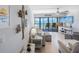 Bright living room featuring ocean views, stylish décor, and comfortable seating area at 14950 Gulf Blvd # 902, Madeira Beach, FL 33708
