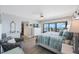 Inviting bedroom with ocean views, light colored walls, light floors and beachy decor at 14950 Gulf Blvd # 902, Madeira Beach, FL 33708